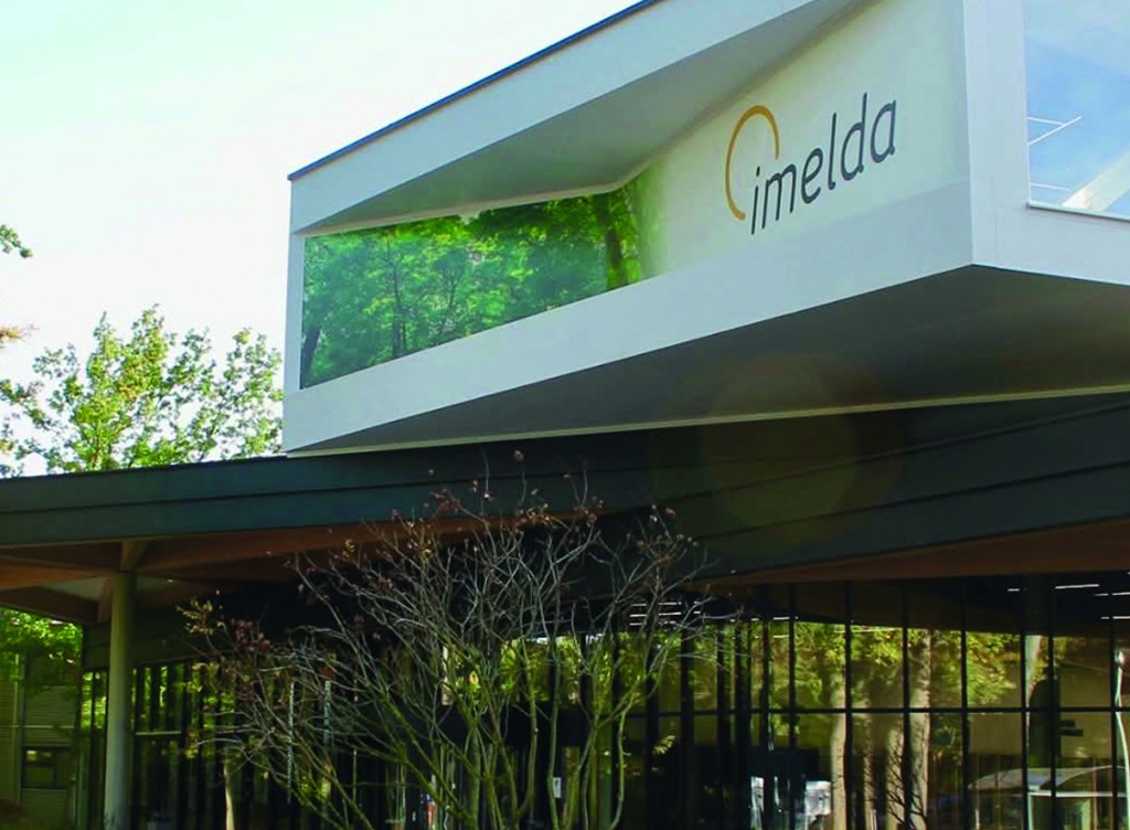 imelda logo printed on the op of a wall of a medical center