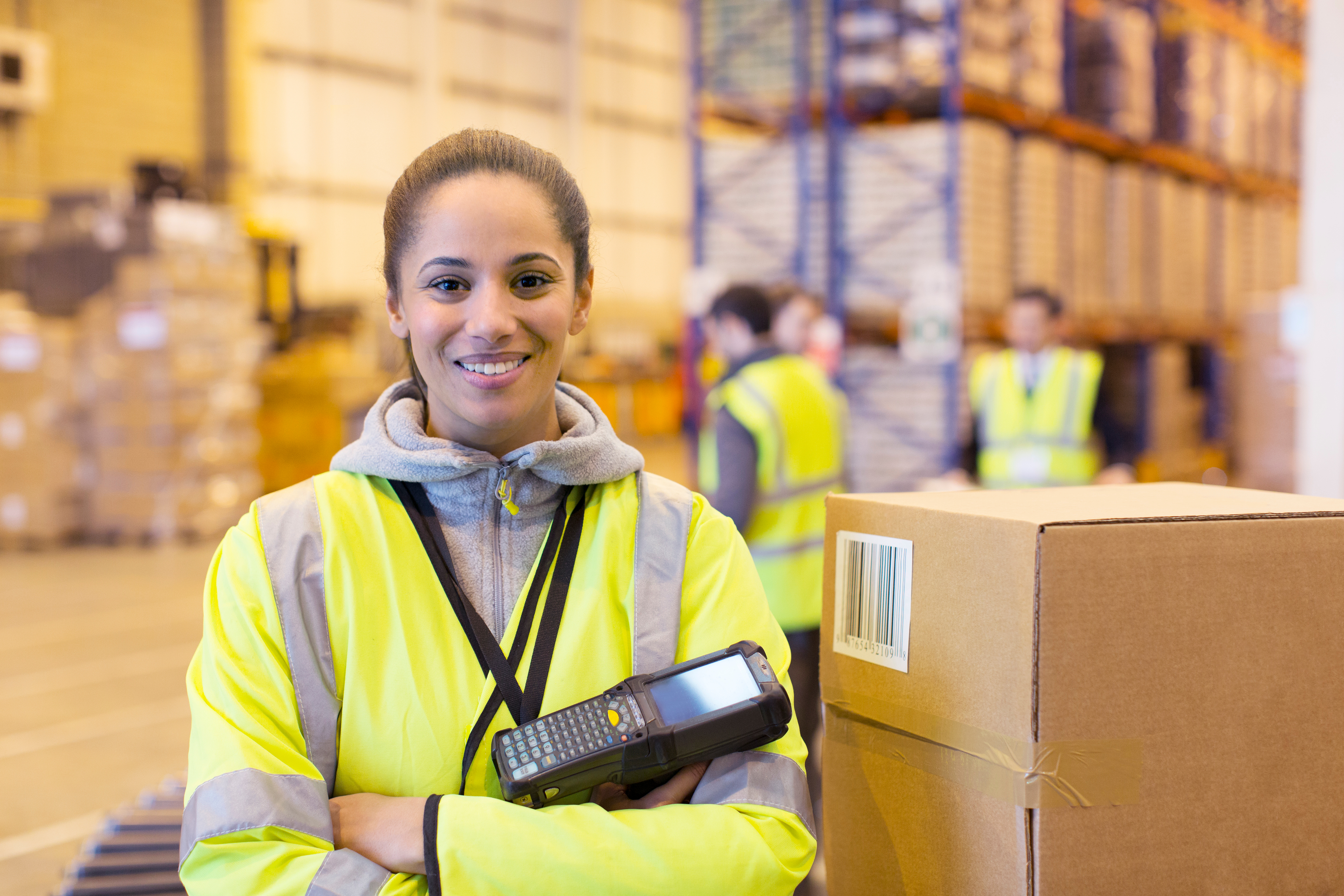 Woman working in a logistics center holding a scanner